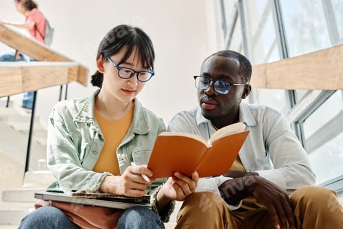 Preview: Students reading book together during break