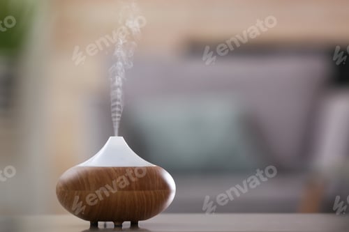 Preview: Aroma oil diffuser lamp on table against blurred background