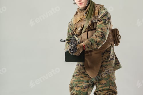 Preview: Soldier in Camouflage Uniform Holding Machine Gun