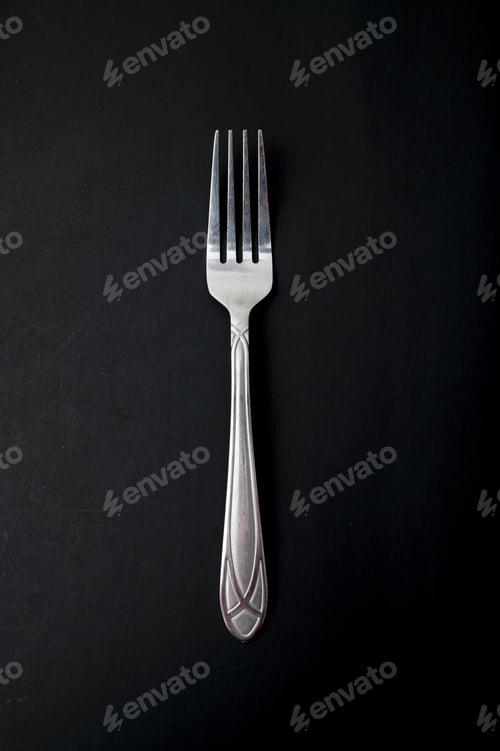 Preview: Top view of the fork on a black background