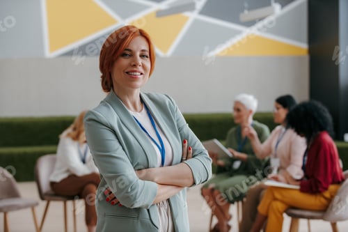 Preview: Confident mature woman looking at camera while visiting group training class for females