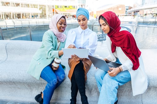 Preview: Beautiful muslim girl wearing hijab bonding outdoors