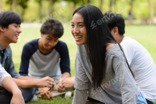 Preview: Happy young group of friends having fun together at the park