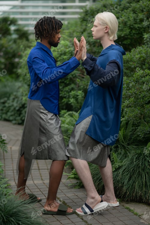 Preview: African American and blonde-haired young men touching hands