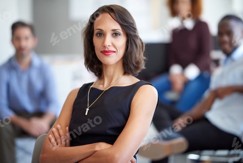 Preview: Portrait of an attractive businesswoman with coworkers in the background