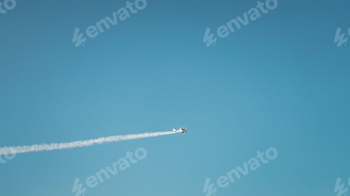 Preview: Low angle shot of a small plane flying in the beautiful clear blue sky