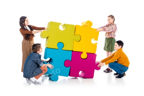 Preview: happy kids playing with jigsaw puzzle pieces on white