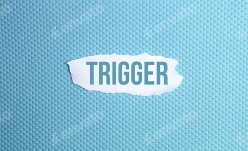 Preview: a torn paper written with inscription trigger on a blue background