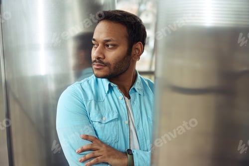 Preview: Close up photo of man looking away at work