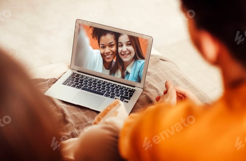 Preview: Portrait of smiling couple with laptop on sofa at home