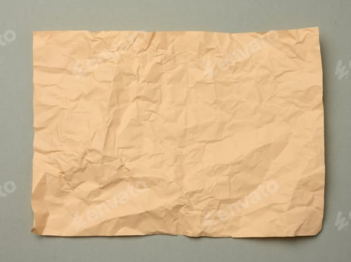 Preview: Blank crumpled beige sheet of paper on a gray background, copy space