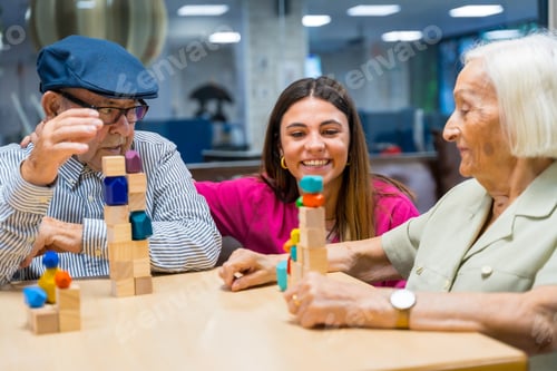 Preview: Nurse supervising seniors playing skill games in a nursing home