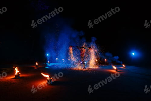 Preview: Fire show, dancing with flame, draws a fiery figure in the dark, bright sparks in the night.