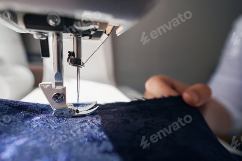 Preview: Clothes being made with sewing machine by man
