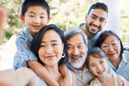 Preview: Trends come and go but family is forever. Shot of a happy family taking selfies in a garden.