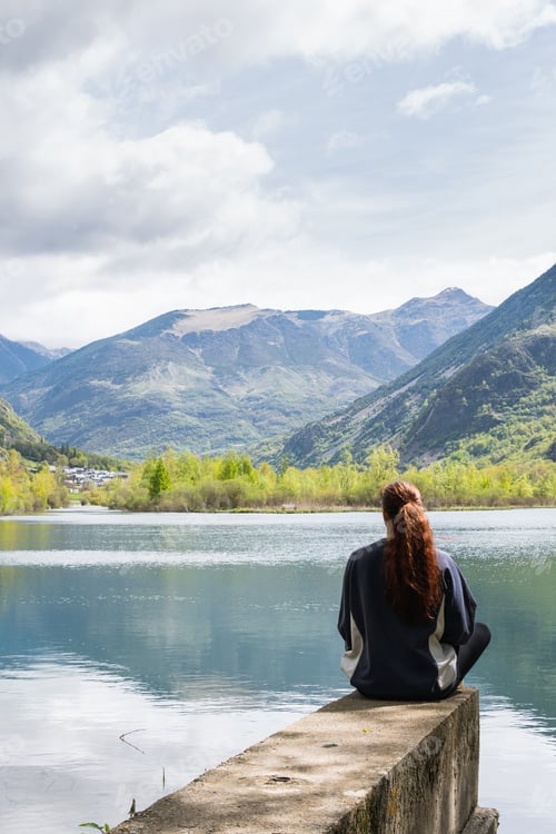 Preview: Carefree traveling woman enjoying freedom near lake in mountains