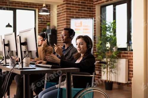 Preview: Woman in Wheelchair Working with Clients
