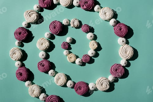 Preview: spiral of berry and white marshmallows on turquoise surface