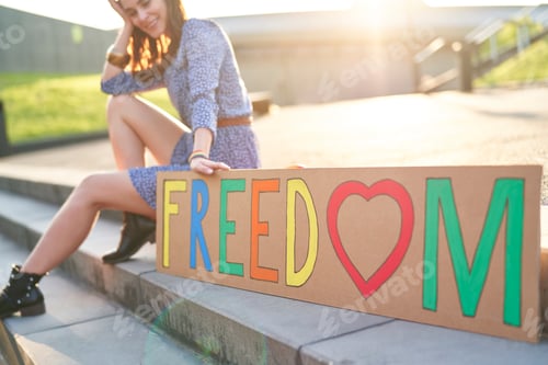 Preview: Beautiful woman sitting with a billboard on the stairs
