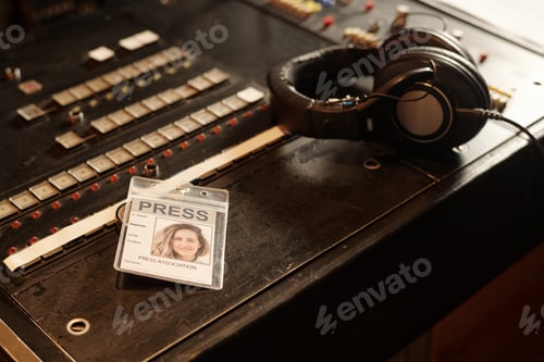 Preview: Badge of female reporter and headphones