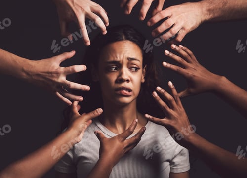 Preview: Shot of hands grabbing a young womans against a dark background