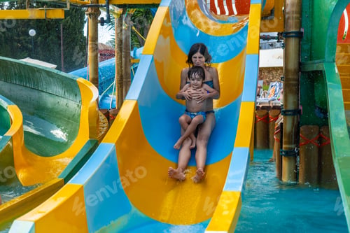Preview: A woman and a child are sliding down a water slide