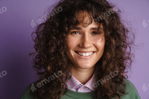 Preview: Happy beautiful curly girl smiling and looking at camera