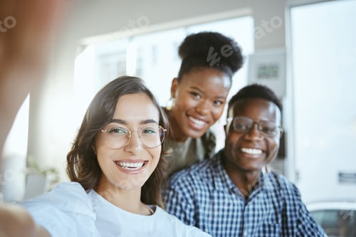 Preview: Portrait of a group of young cheerful businesspeople taking a selfie together at work. Happy hispan
