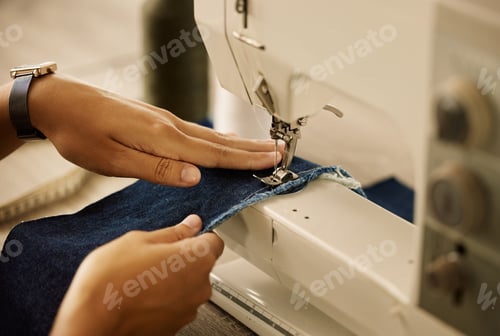 Preview: Creative designer stitching denim fabric on a sewing machine. Fashion designer using sewing machine
