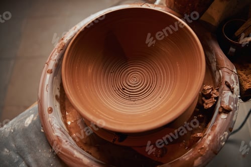 Preview: Image of fresh clay bowl on pottery wheel in art studio