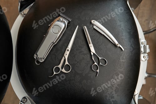 Preview: Set of various tools on black barber chair