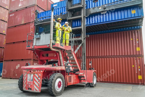 Preview: Workers manage shipping containers at a busy port during daytime operations