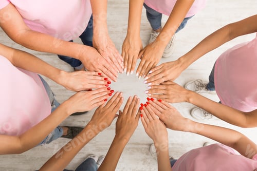 Preview: Women In Pink T-Shirts Holding Hands In Circle Indoor, Top-View