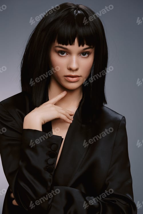 Preview: Black suit woman posing, hand and finger on chin, looking off to the side thoughtfully