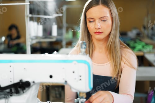 Preview: Portrait of seamstress working with sewing machine