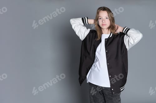 Preview: A teenage girl in profile with a varsity jacket resting on her shoulder, giving off a relaxed vibe