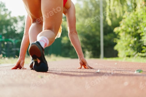 Preview: Athlete starting sprint on running track outdoors