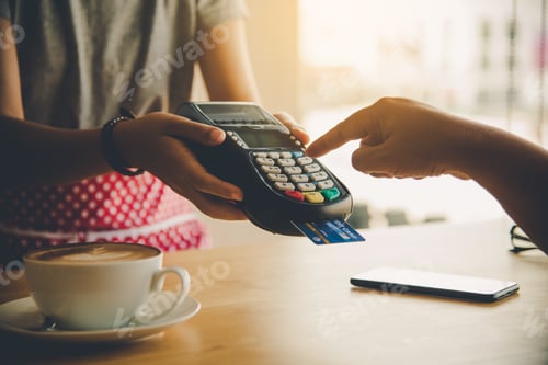 Preview: Close up of hand using credit card to pay by sending the credit card