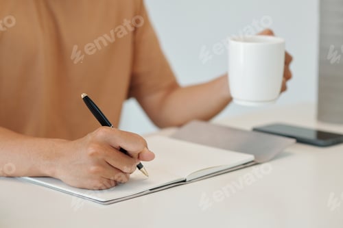 Preview: Young Man Writing Plans for Day