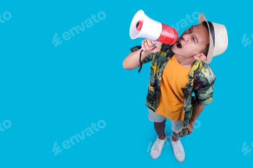 Preview: Traveler Guy Shouting Into A Megaphone, Looking Up With An Open Mouth On A Blue Background
