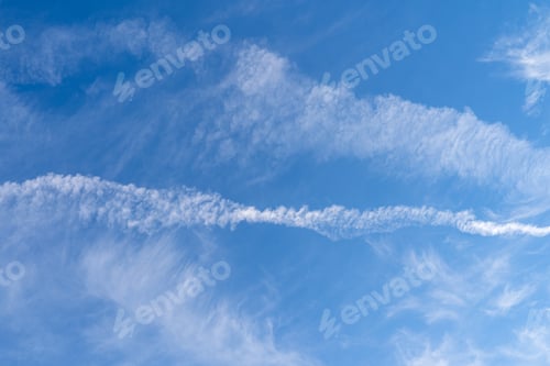 Preview: Blue sky with clouds and condensation trails
