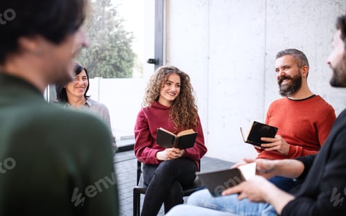 Preview: Men and women sitting in circle during group therapy, reading and talking