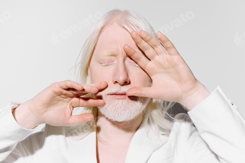 Preview: Portrait of a serene individual with white hair and fair skin, eyes closed, hands raised in a