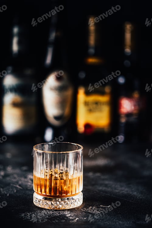 Preview: Whiskey with ice on a dark table
