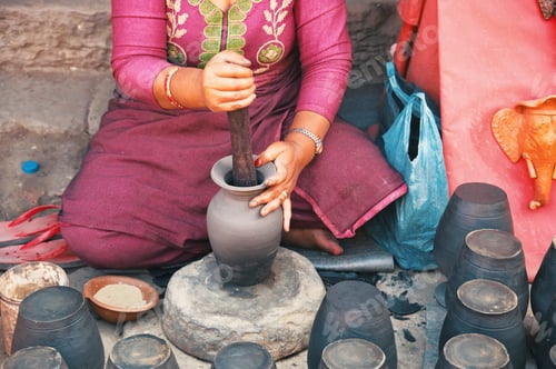Preview: Midsection of professional potter making bowl in pottery workshop - Kathmandu