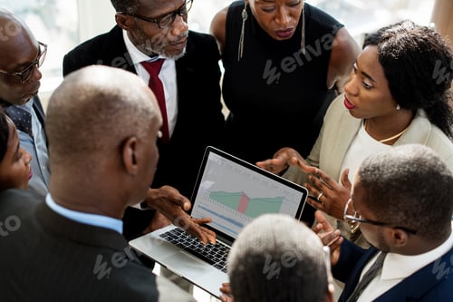 Preview: Group of International Business People Having Discussion with Laptop