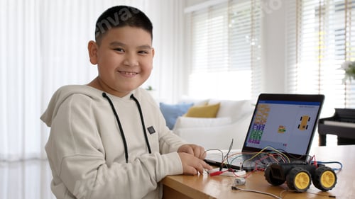 Preview: Young asia student remotely learn online at home in coding robot car