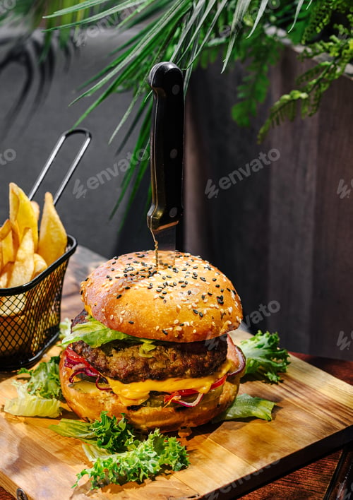 Preview: Delicious burger served with golden fries in a cozy dining setting