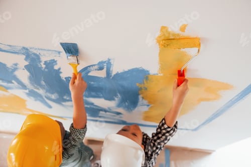 Preview: Colors of Ukrainian flag. Two boys painting walls in the domestic room