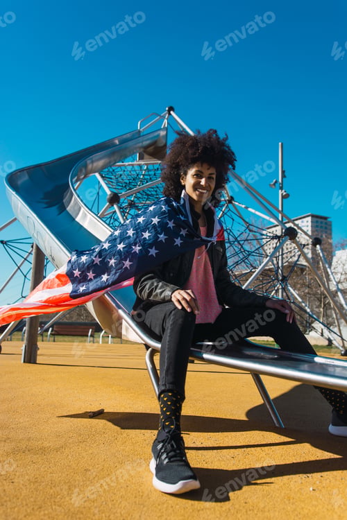 Preview: black woman with afro hair and an american flag.